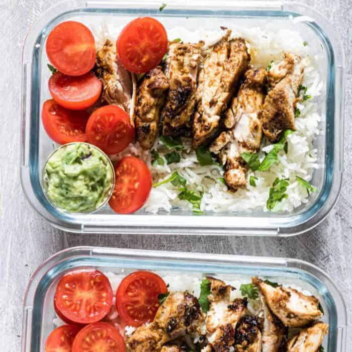 two lunchboxes with meal prep chicken and rice