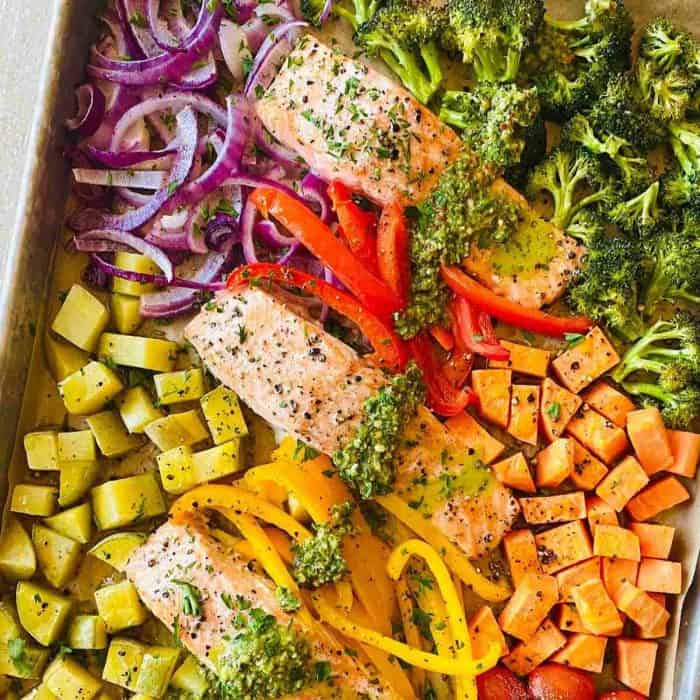 a close up photo of sheet pan salmon and veggies
