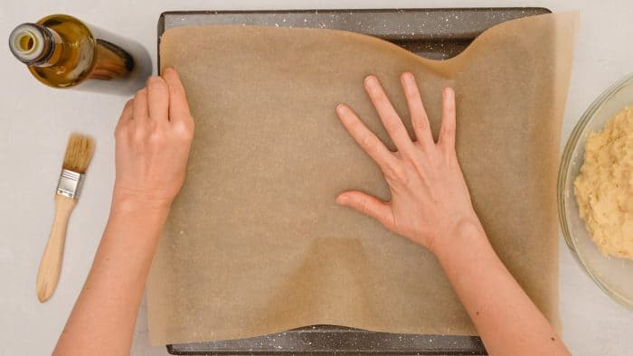Begin by heating your oven to 425°F and prepare a baking sheet by lining it with parchment paper or a non-stick baking mat.
