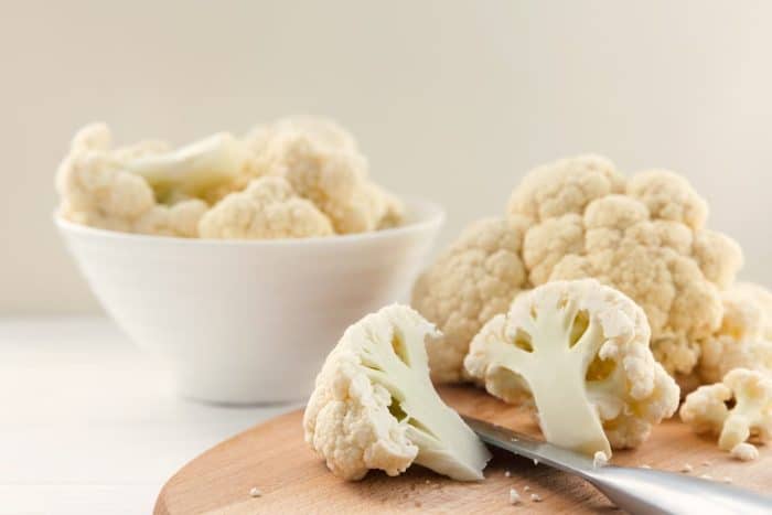 Carefully cut the cauliflower into two equal parts. Cut thick slices of one part to create “steaks” and cut the other part into smaller florets.