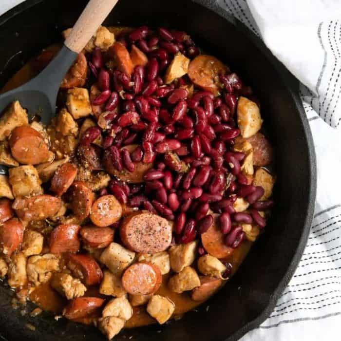 a photo of spicy cajun sausage and chicken skillet on a black pan