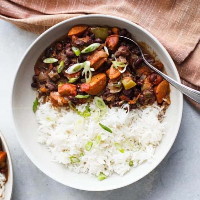 a photo of easy black beans and rice recipe on a white bowl placed on a table