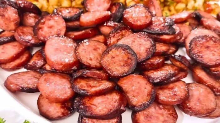 a close up photo of air fyer smoked sausage spread on a plate