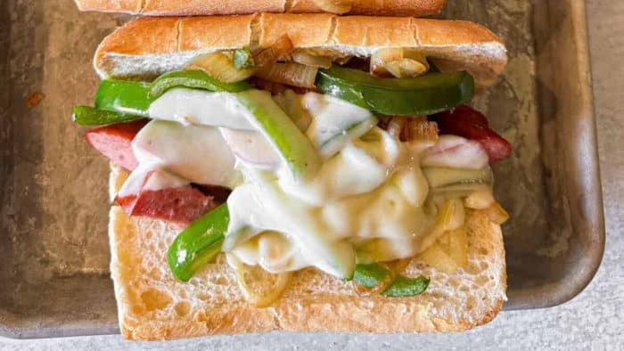 a photo of kielbasa sausage sandwich on a baking pan