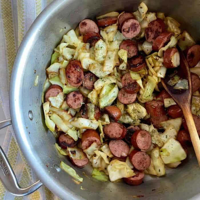 a photo of southern fired cabbage with sausage on a casserole