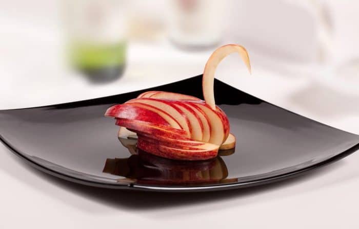 apple swan placed on a black plate