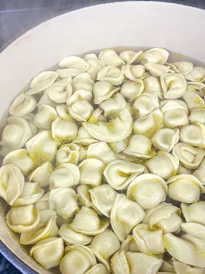 Cook the tortellini according to the package directions, adding a touch of extra virgin olive oil to the boiling water to prevent the pasta from sticking. 
