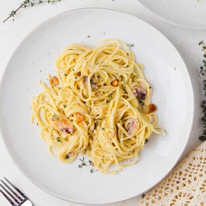 a plate of 40 Clove Garlic Pasta with a fork beside it