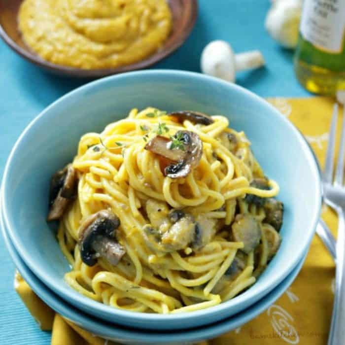 a small blue bowl filled with vegan Kabocha Truffle Pasta 