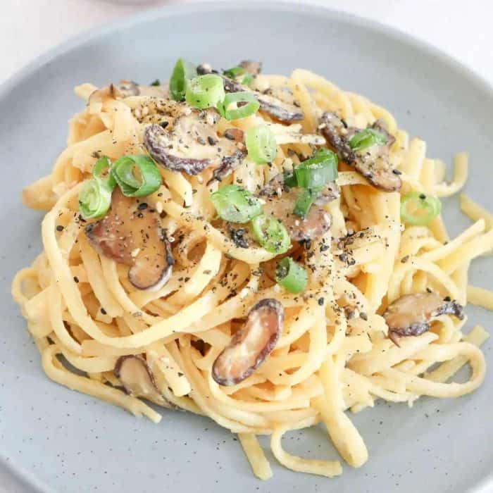 a photo of creamy miso pasta on a light gray plate

