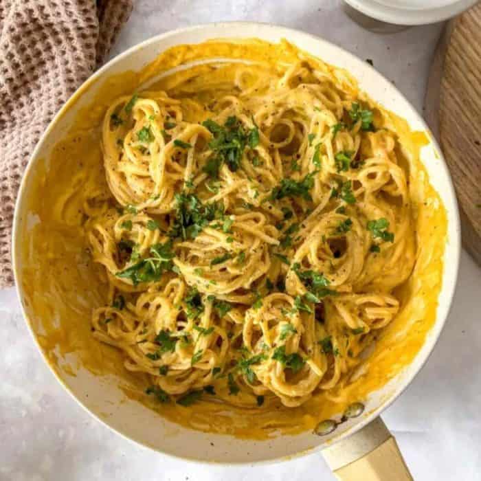 a photo of vegan Butternut Squash Pasta on a white bowl