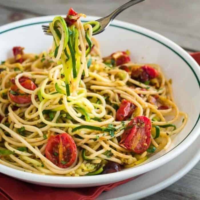 a plate of zucchini Noodles with Pasta and Roasted Tomatoes 