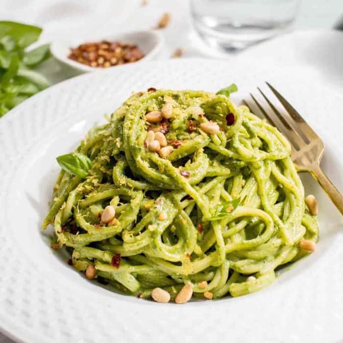 a plate of pasta With Green Sauce with a fork on the side