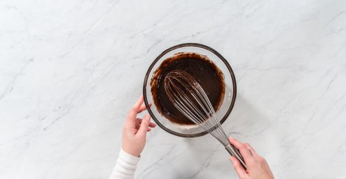 Stir in the pure vanilla extract and salt into the melted chocolate mixture until fully incorporated. Continue stirring until the mixture becomes completely smooth and glossy.
