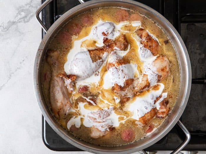 Add heavy cream to the pan and season with salt and pepper to taste. Continue to simmer until the chicken is fully cooked through.