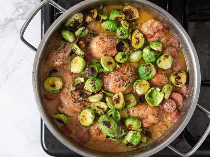 Slice the Brussels sprouts in half. In a skillet, cook Brussels sprouts until brown over medium heat. 