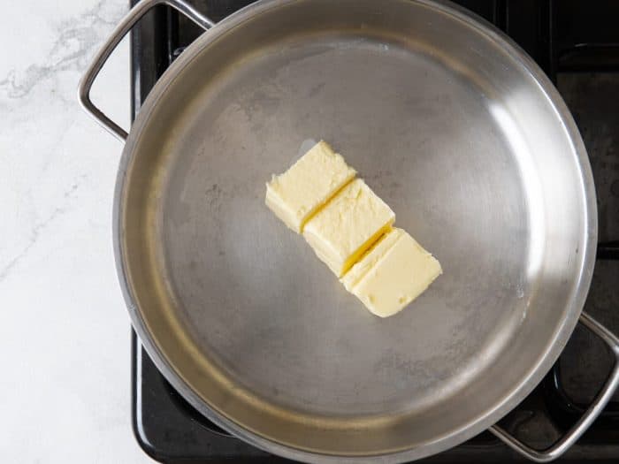  In a large deep pan or Dutch oven melt the butter over medium heat. 