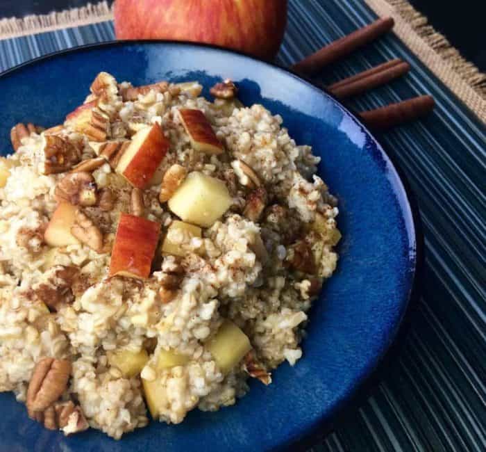 A colorful display of steel-cut oats, fresh apple cider, diced apples, honey, and a blend of spices lay the foundation for this cozy breakfast.