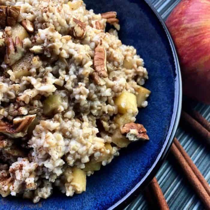 A colorful display of steel-cut oats, fresh apple cider, diced apples, honey, and a blend of spices lay the foundation for this cozy breakfast.