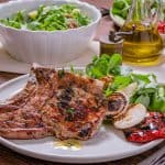 These grilled pork chops are not your average dinner; they're a symphony of basil, thyme, and rosemary, married with the unmistakable char of a grill.
