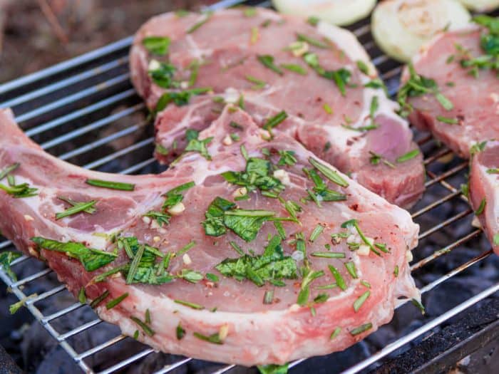 Lightly oil clean grill grates and preheat to medium heat. Once hot, grill the pork chops over direct heat while covered for 6 to 8 minutes, flipping once. 