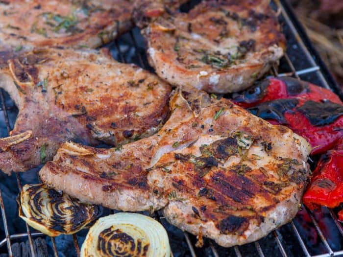 Remove the pork chops from the grill, cover them, and let them rest for 3 to 5 minutes. This allows the juices to be redistributed, ensuring each chop is moist and flavorful.