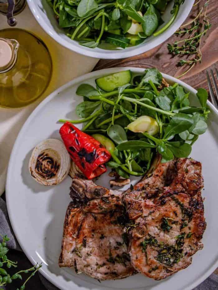 Serve the pork chops with freshly grilled veggies and a side of salad for a complete meal! You can also chop extra herbs and mix them with melted butter to drizzle over the dish.