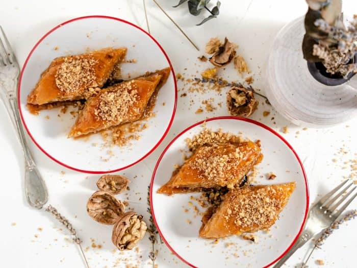 Cover the baklava, and let cool at room temperature for at least 4 to 6 hours. Once ready to serve, take a slice and top with some chopped walnuts.