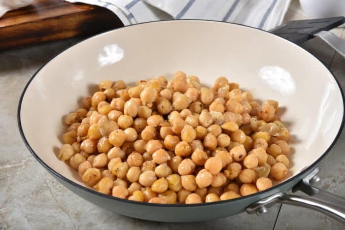 Fried chickpeas in an enamel coated cast iron skillet