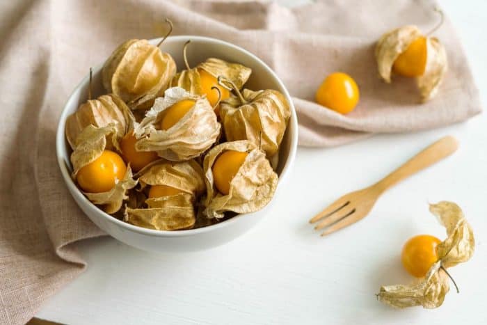 Close up of Cape gooseberry fruit on white wooden background