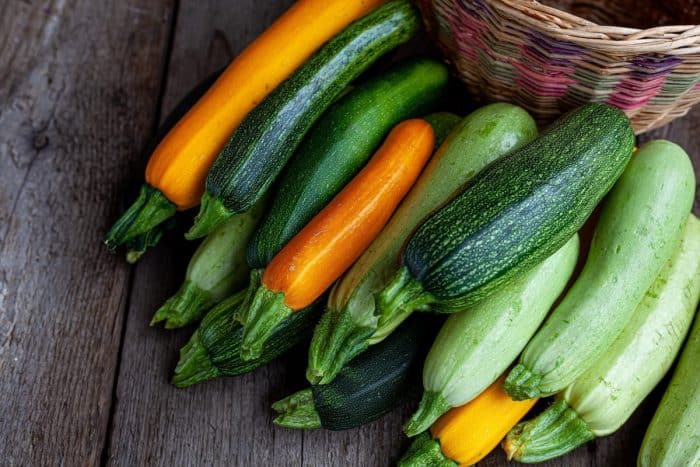 A set of multi-colored zucchini yellow, green, white, orange on the table close-up. 