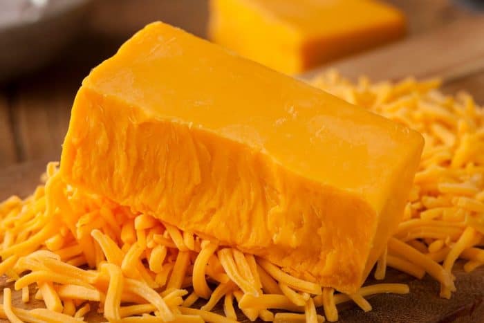 Organic Sharp Cheddar Cheese on a wooden table
