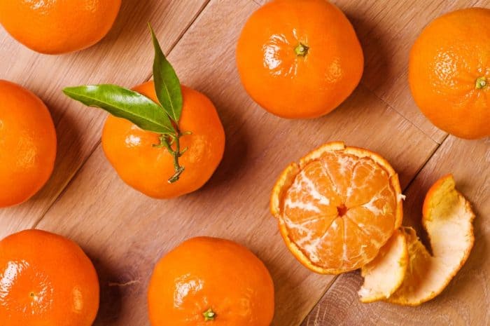 fresh clementine placed on a wooden table