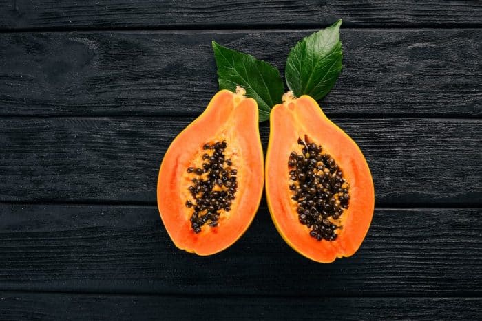 sliced papaya placed on a wooden table