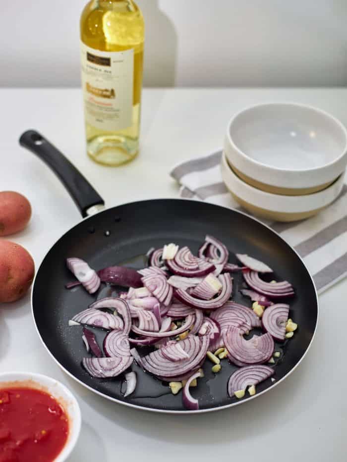 On medium heat, sauté the onions until translucent and the remaining garlic until golden brown.
