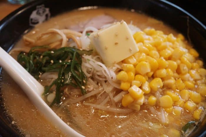 a bowl of japanese ramen topped with miso butter