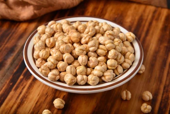 a plate full of Healthy roasted chickpeas on a wooden table