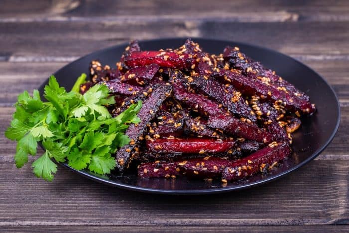 Roasted beetroot in black plate, close up