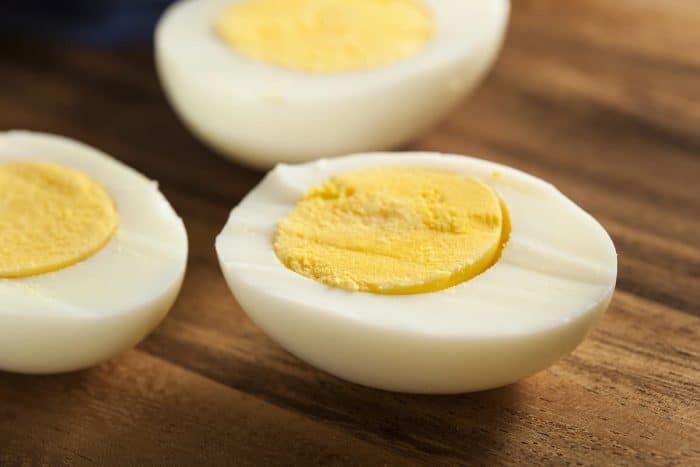 Organic Hard Boiled Eggs placed on a wooden table