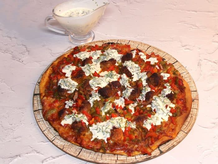 homemade sausage and pepper pizza a symphony of flavors with a creamy garlic twist