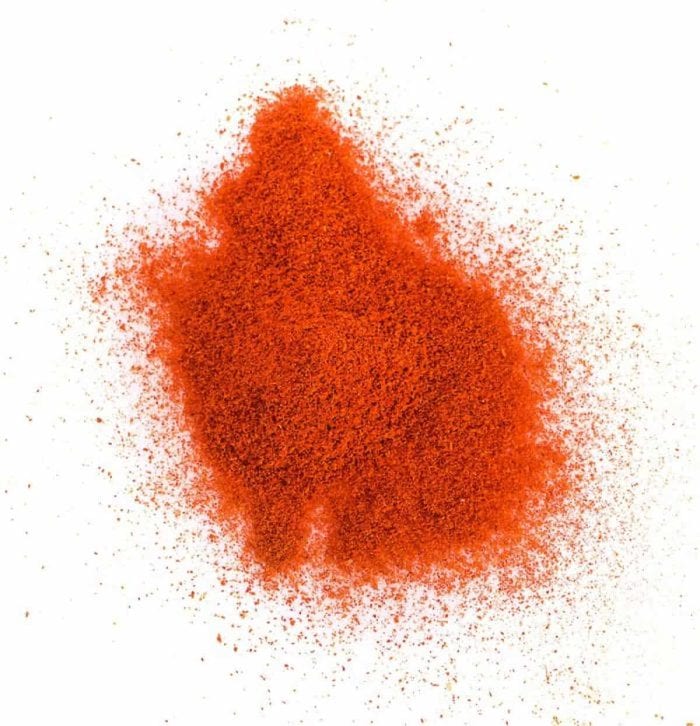 "Pile of red paprika powder isolated on white background