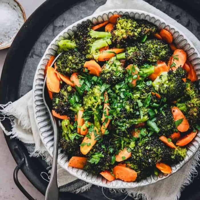 This dish enhances the natural flavors of the vegetables through roasting and is seasoned with garlic, parmesan, and a squeeze of lemon for extra zest.