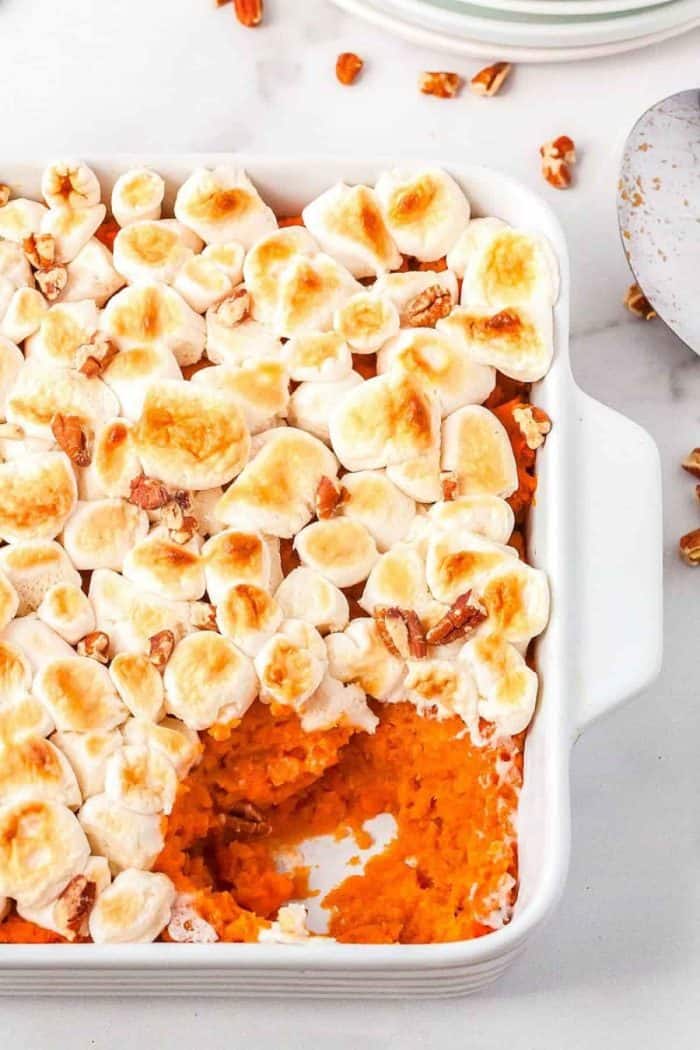It features a sweet and fluffy sweet potato base with a crunchy pecan topping, making it a must-have dish for festive gatherings.