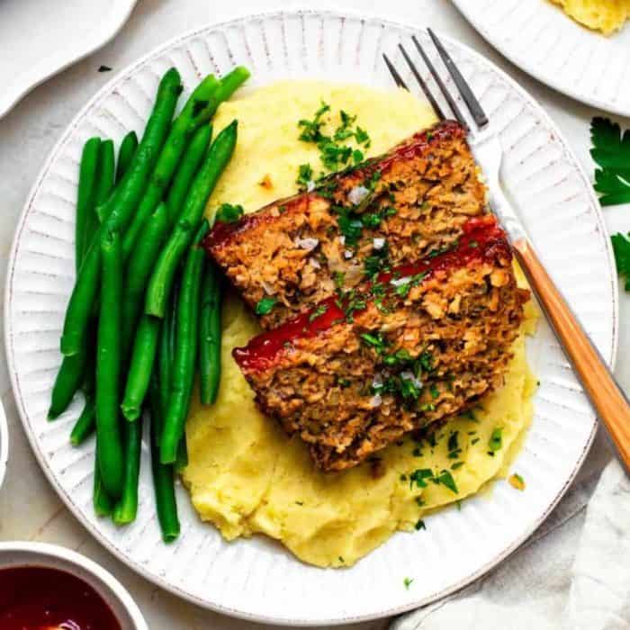 The meat loaf, made with plant-based Beyond Meat, is meaty and juicy and topped with a sweet and tangy glaze. It's perfect for any family dinner or special occasion.