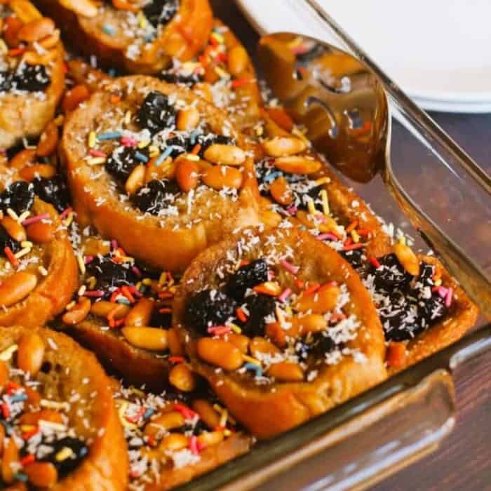 Capirotada is Mexico’s cherished traditional bread pudding, usually eaten during Lent. This dairy-free dessert combines spices, nuts, and dried fruits to create a historically rich and flavorful experience.