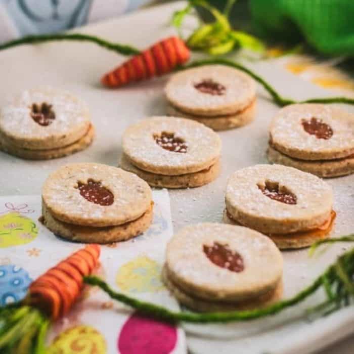 Simple, sweet, and tangy, these vegan cut-out cookies with apricot jam are great snacks to nibble on while the kids are hunting down those Easter eggs!