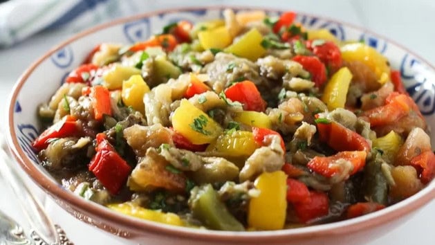 The smoky softness of roasted eggplant meets the crispness of fresh tomatoes and bell peppers in this recipe. 