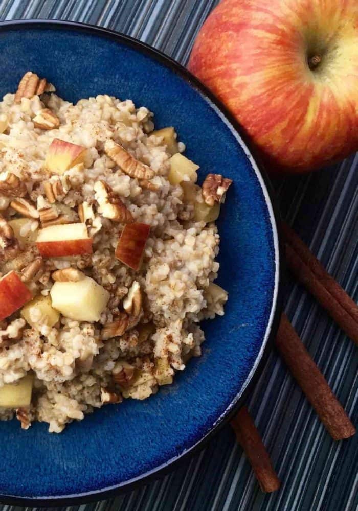A colorful display of steel-cut oats, fresh apple cider, diced apples, honey, and a blend of spices lay the foundation for this cozy breakfast.