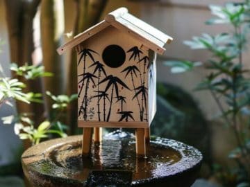 The minimalist approach of a Zen painting with bamboo creates a tranquil environment in your garden.