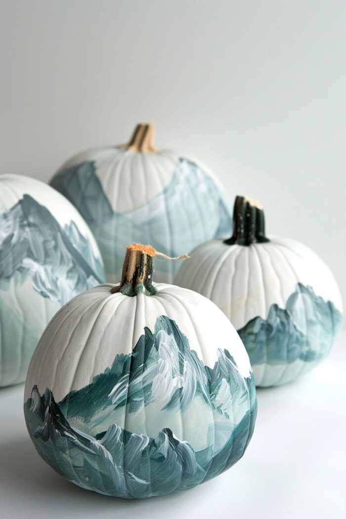 These pumpkins are transformed into tranquil landscapes featuring majestic, snow-capped mountains beneath a soft, pastel sky. 